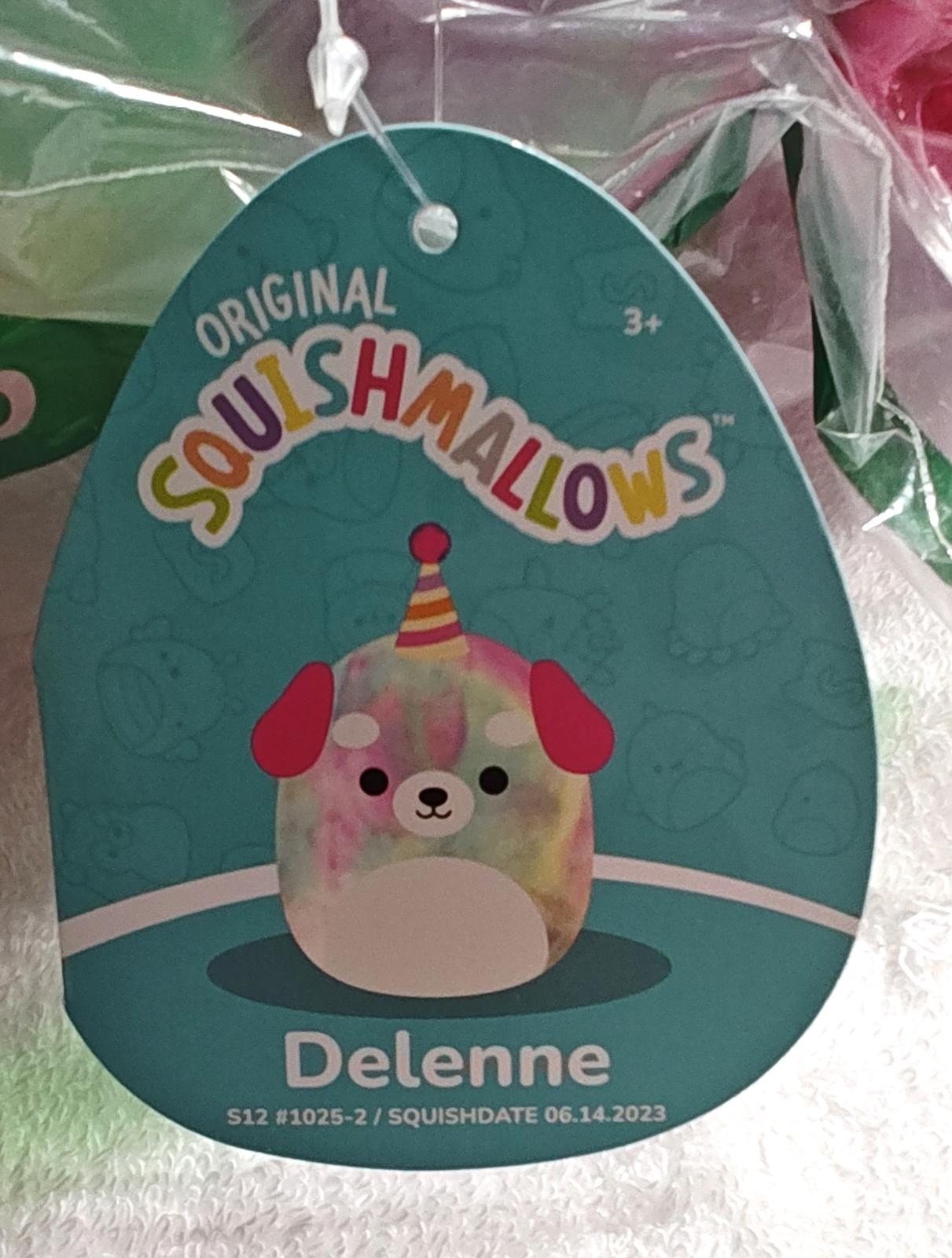 Delenne Squishmallow featuring a colorful dog design with a party hat.