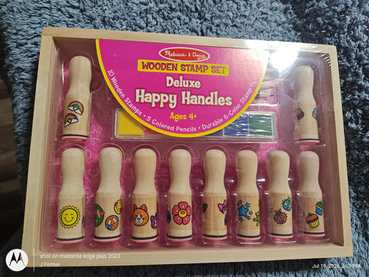 Deluxe Happy Handles wooden stamp set featuring colorful designs and handles for creative fun.