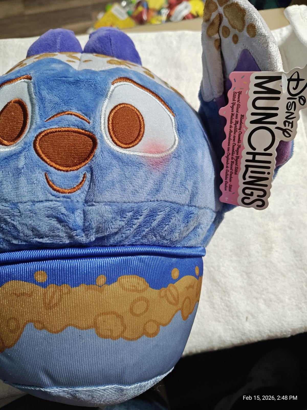 Disney Munchlings plush toy featuring a blue character with cookie details and a happy expression.