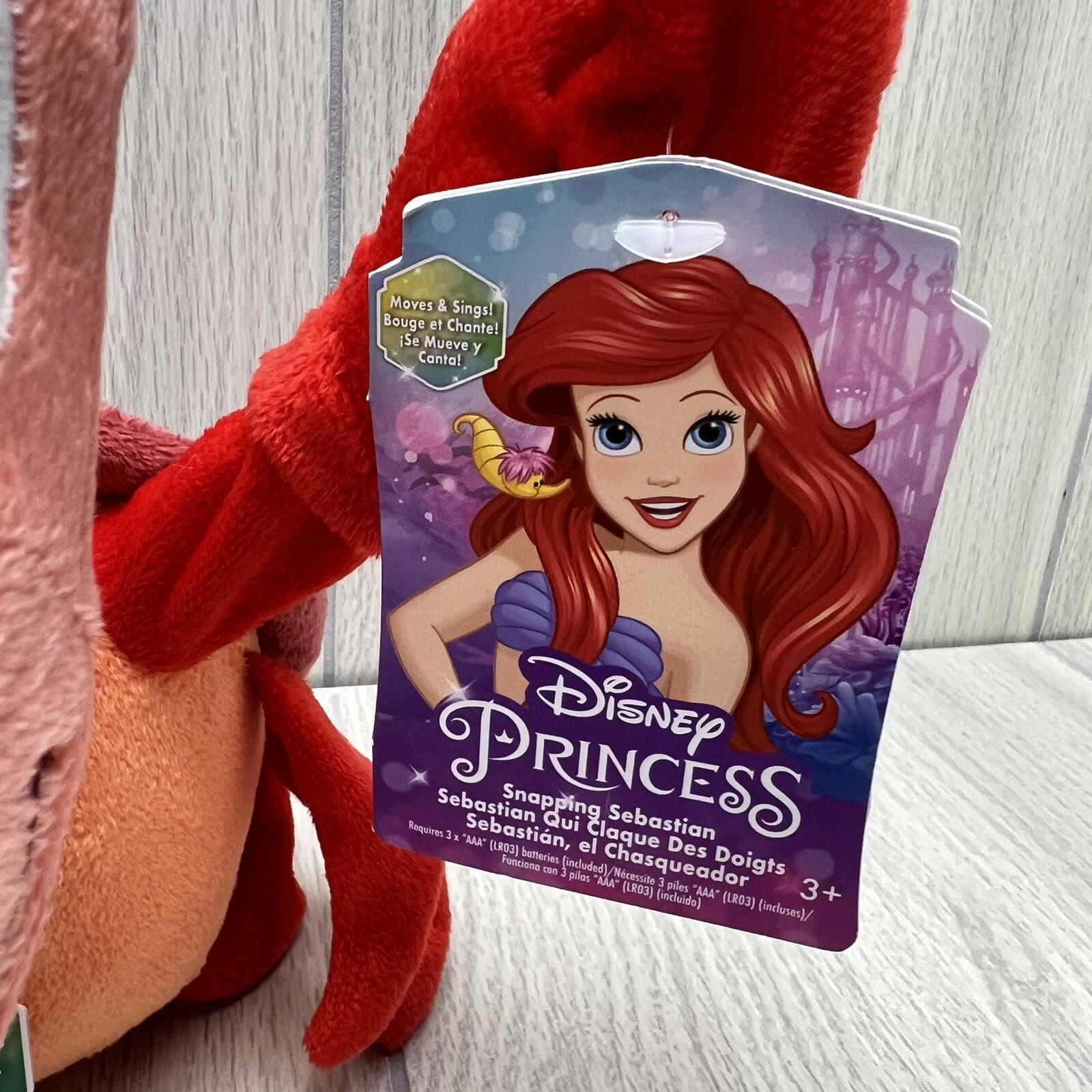 Disney Princess Ariel plush toy with vibrant red hair and tag featuring character design.