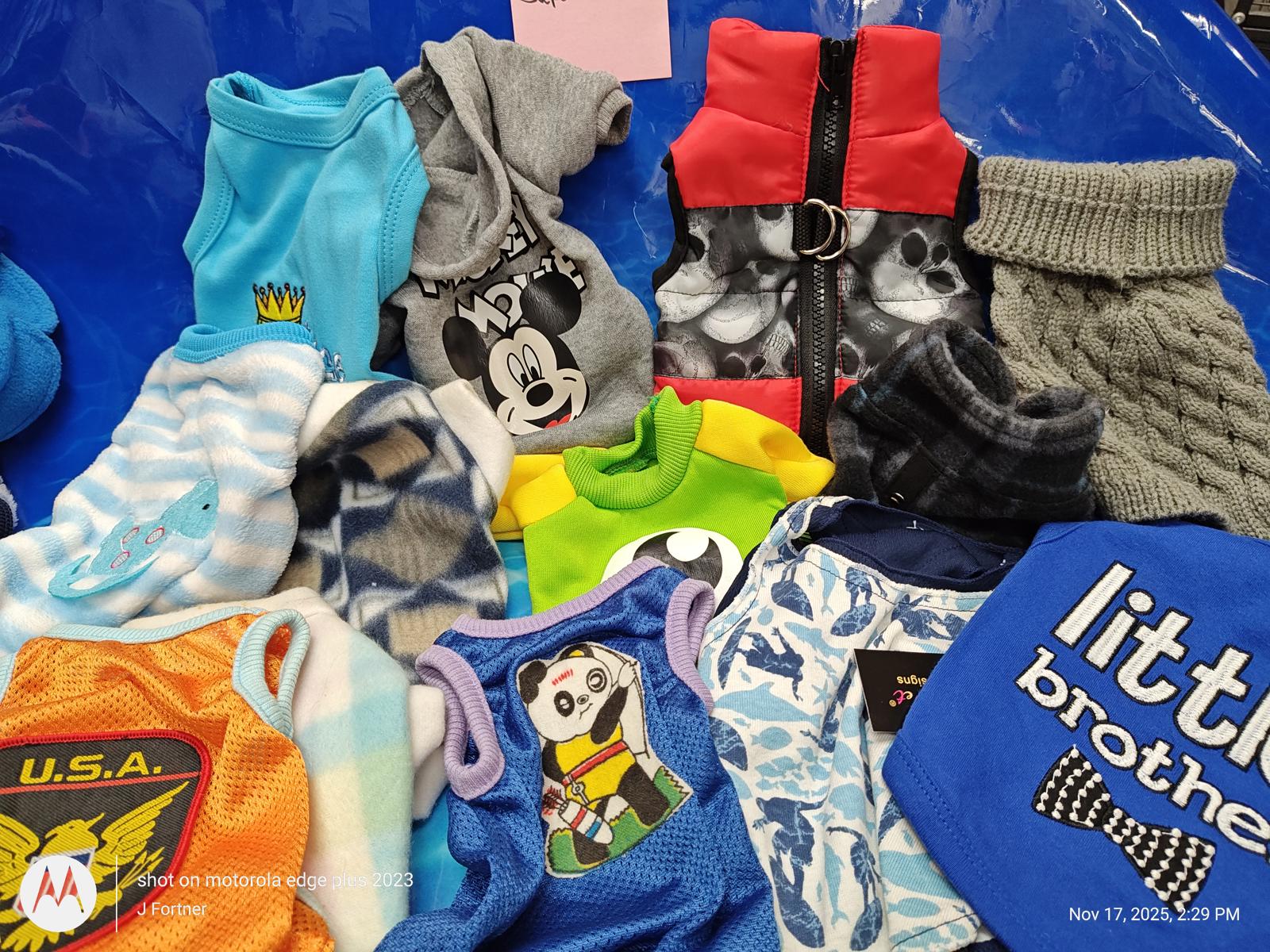 Dog apparel collection featuring various styles and colors, including a Mickey Mouse design.