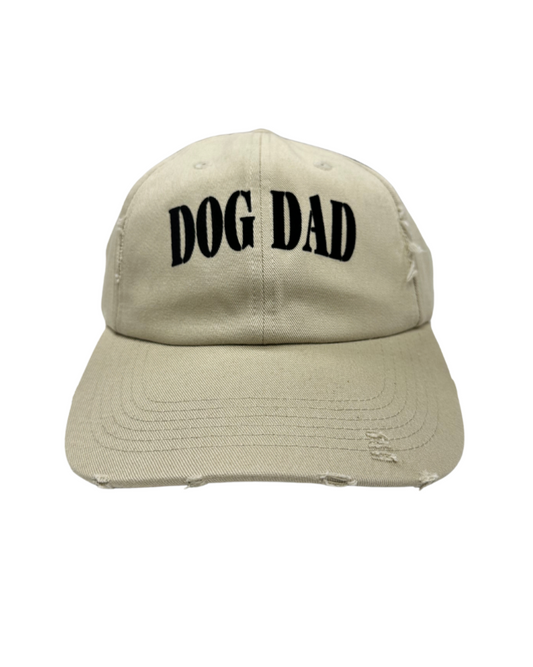Dog Dad cap featuring a distressed beige design with bold black lettering.