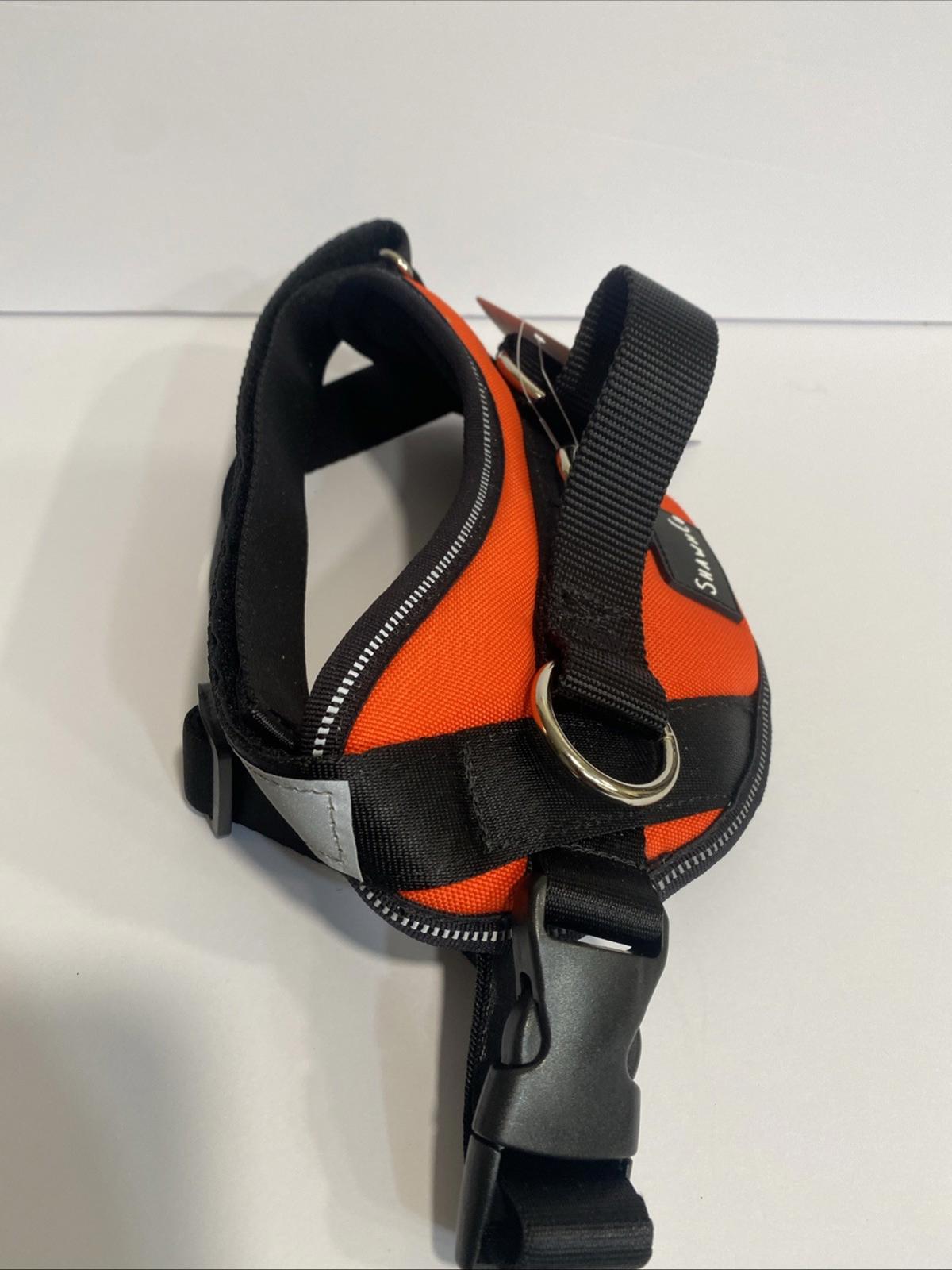 Dog harness in bright orange color with adjustable straps and metal D-ring.