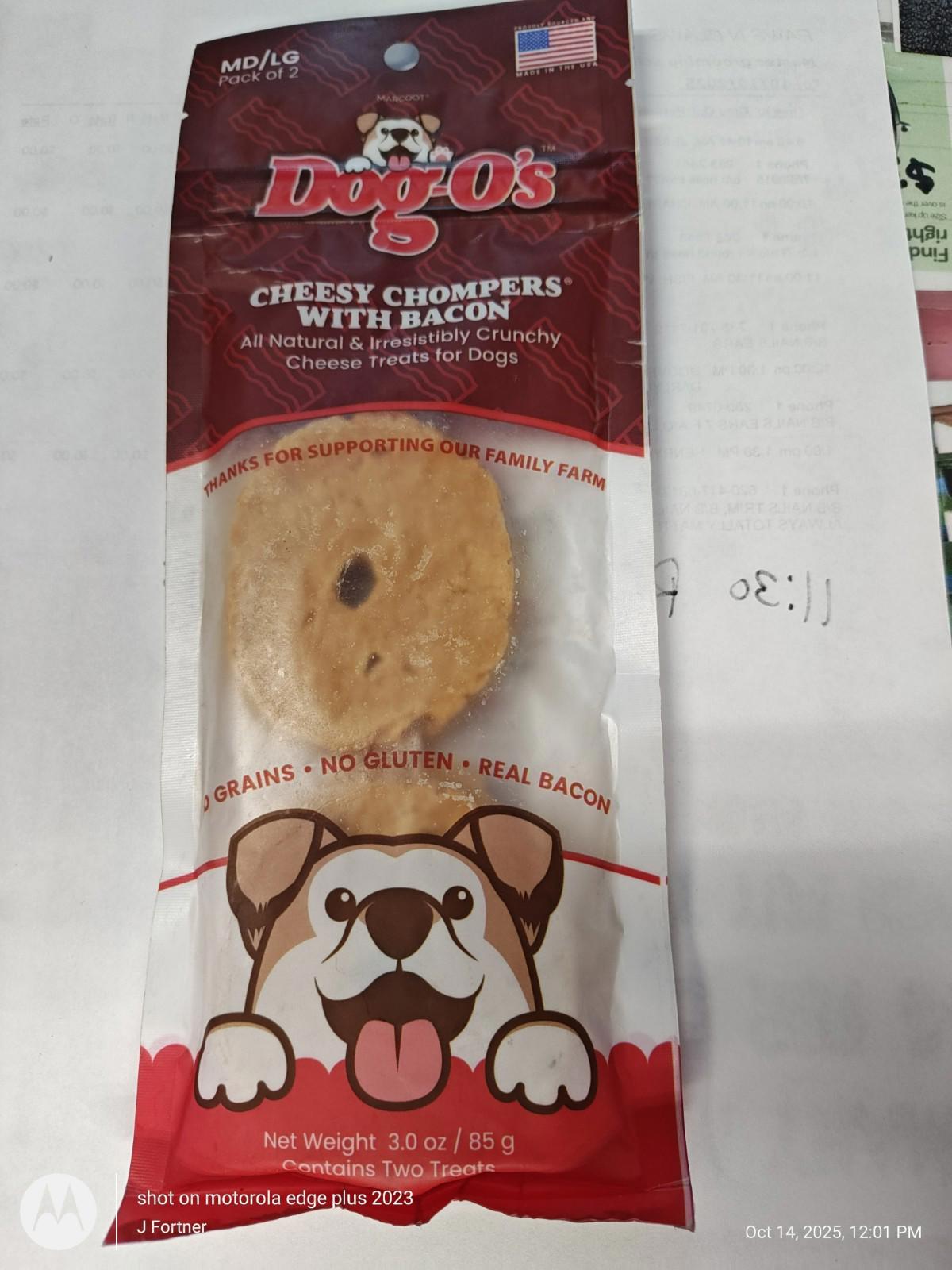 Dog O's Cheesy Chompers with Bacon, a crunchy dog treat in packaging featuring a playful dog design.