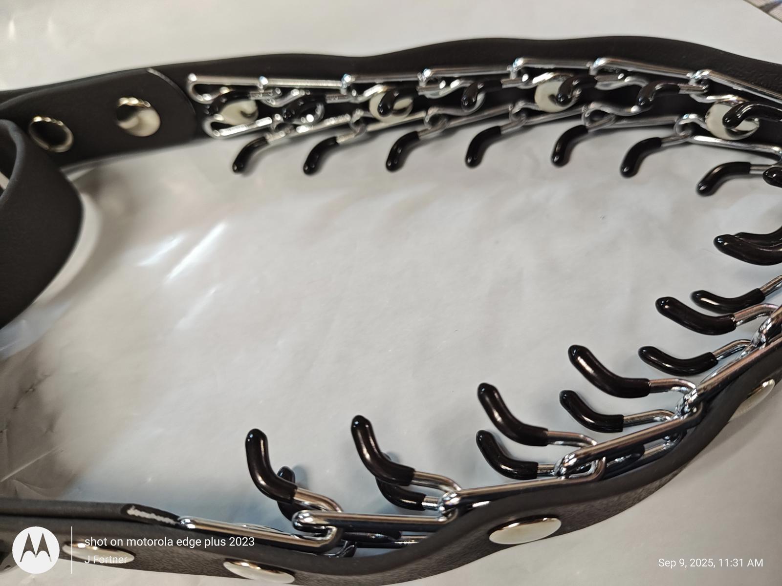 Dog training collar with metal prongs and black leather design.