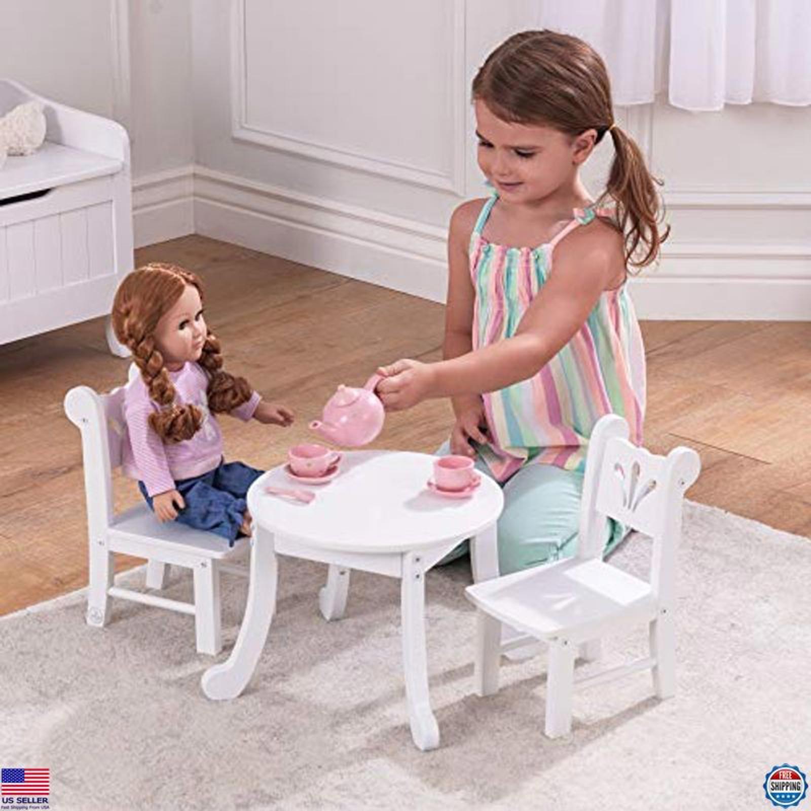 Doll Tea Set Table with Chairs featuring a girl serving tea to her doll.