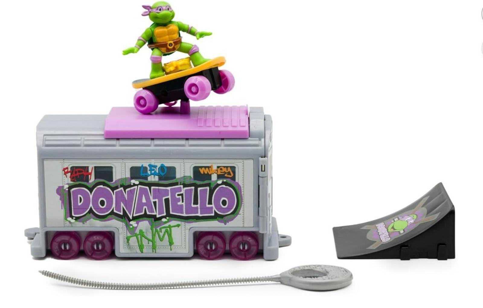 Donatello skateboard toy set featuring a green figure on a pink skateboard and a ramp.