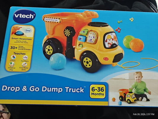 Drop & Go Dump Truck by VTech features colorful design and interactive elements for toddlers.