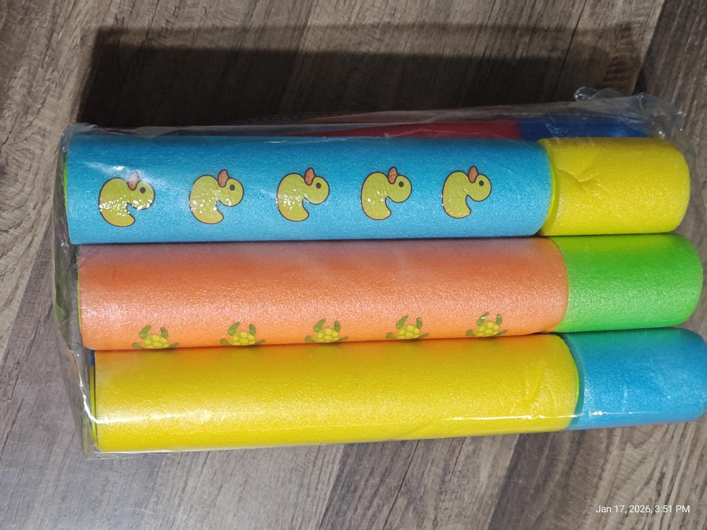Duck-themed wrapping paper rolls in blue, orange, yellow, and green colors.