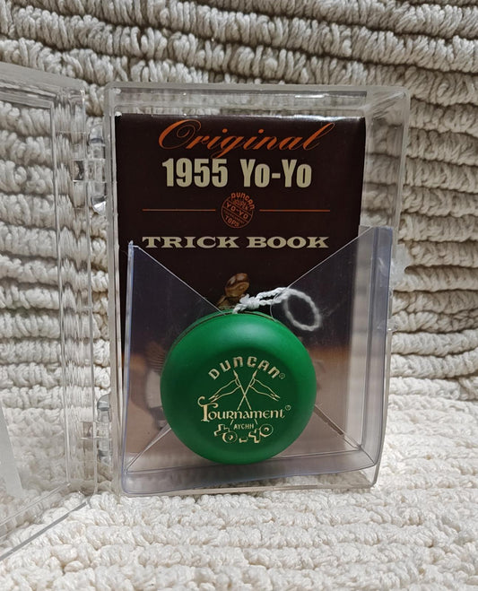 Duncan Tournament Yo-Yo with original 1955 trick book in background.