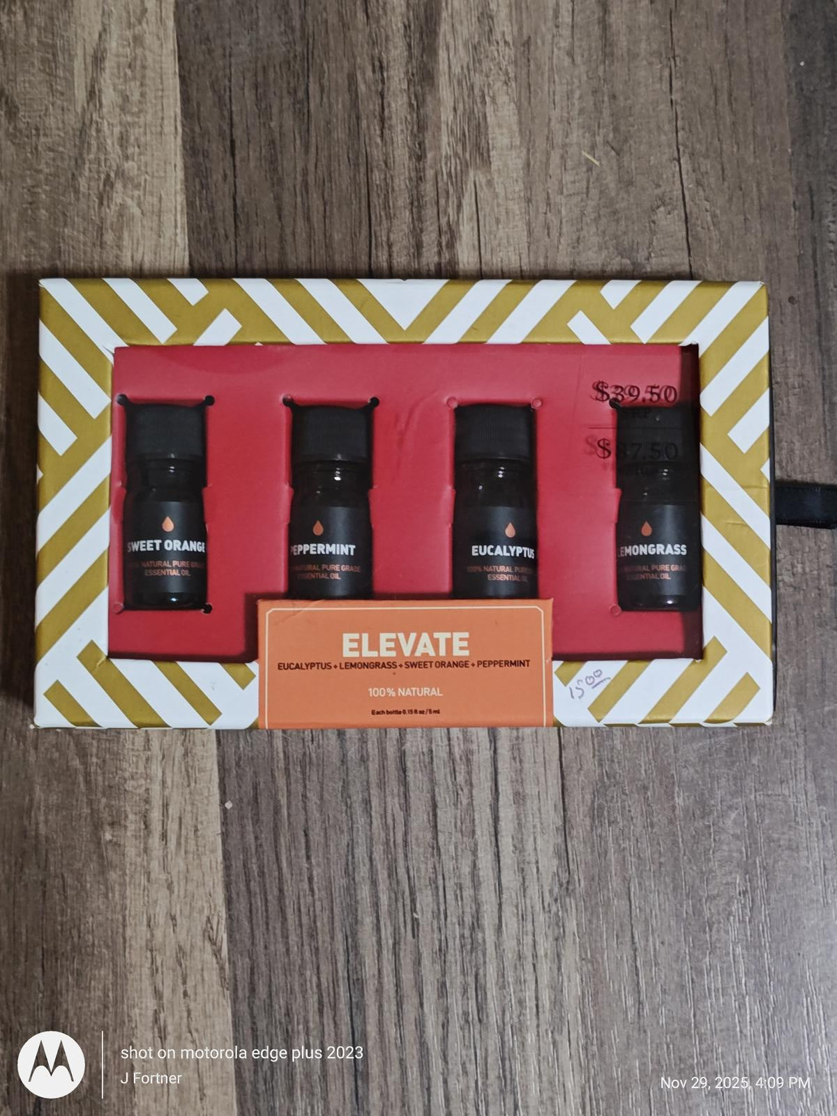 Elevate gift set featuring four essential oils in sleek black bottles, perfect for relaxation.