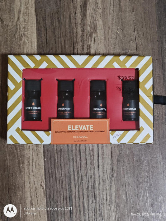Elevate gift set featuring four essential oils in sleek black bottles, perfect for relaxation.