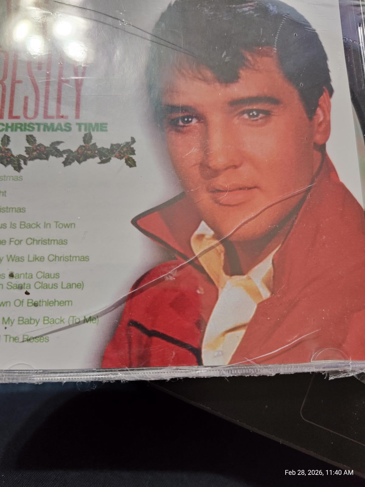 Elvis Presley Christmas Time album cover featuring Elvis in a red jacket.