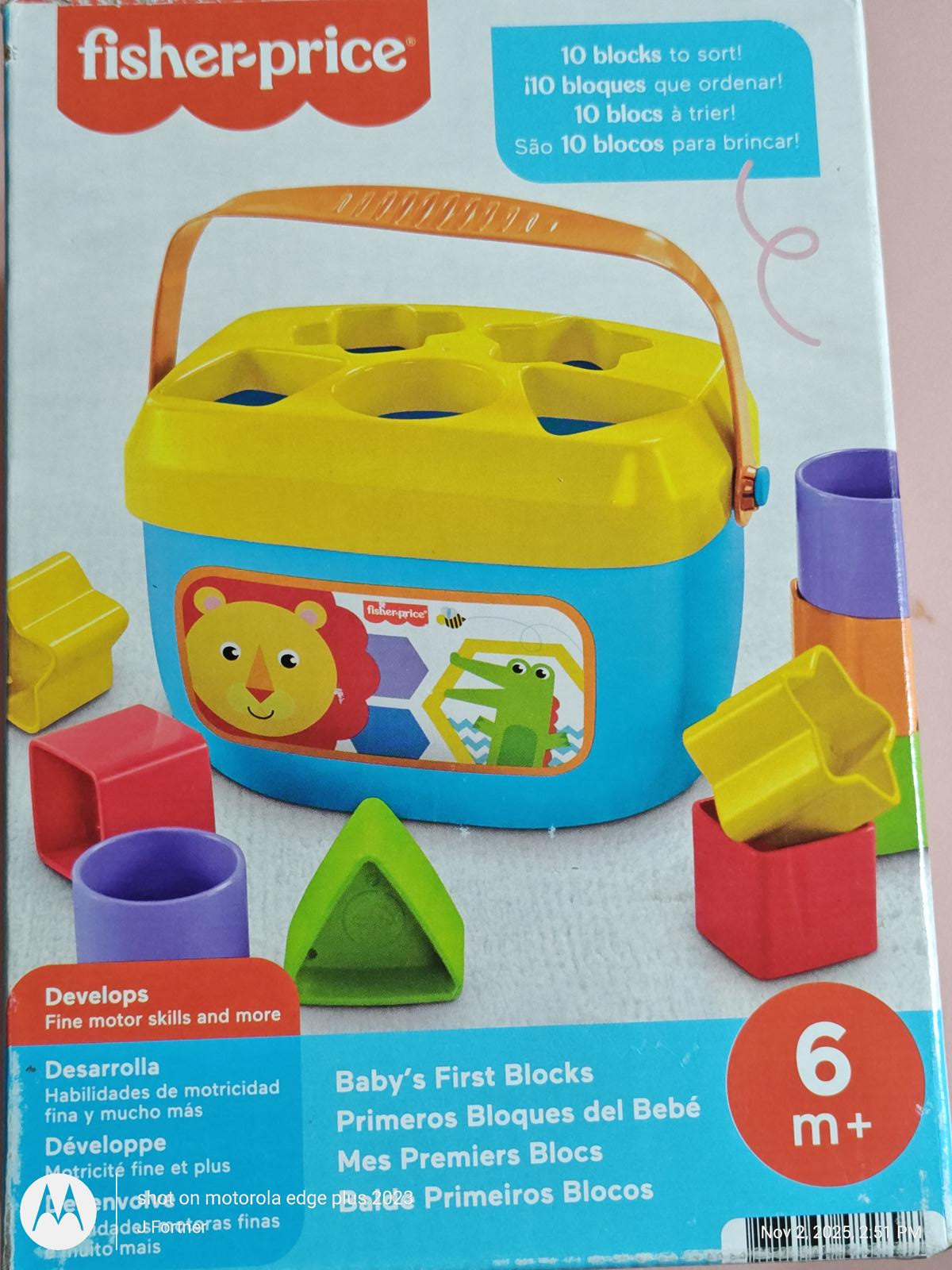 Fisher-Price Baby's First Blocks set with colorful sorting blocks and a blue container.