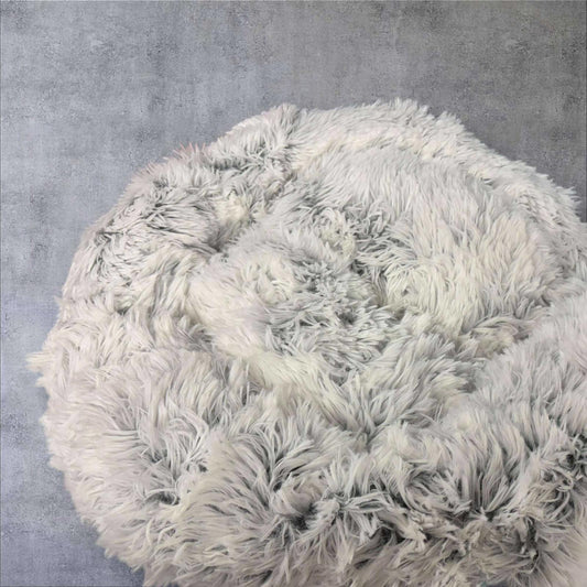 Fluffy White Round Pouf with Soft Texture for Cozy Seating.