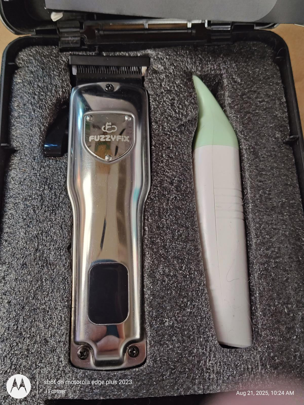 FuzzyFix hair clipper set with stainless steel trimmer and grooming tool in a protective case.
