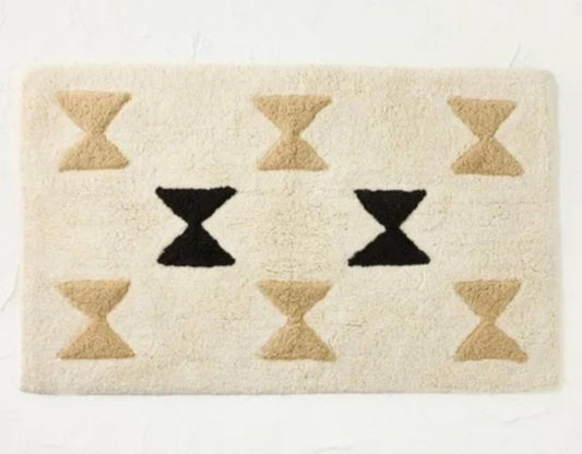 Geometric Cream Area Rug featuring black and beige hourglass patterns.