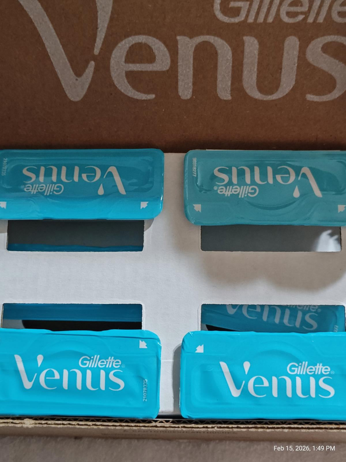 Gillette Venus razor blades in blue packaging, neatly arranged in a box.
