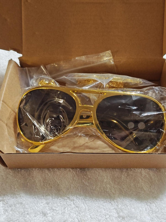 Gold Aviator Sunglasses in packaging with dark lenses and shiny frame.
