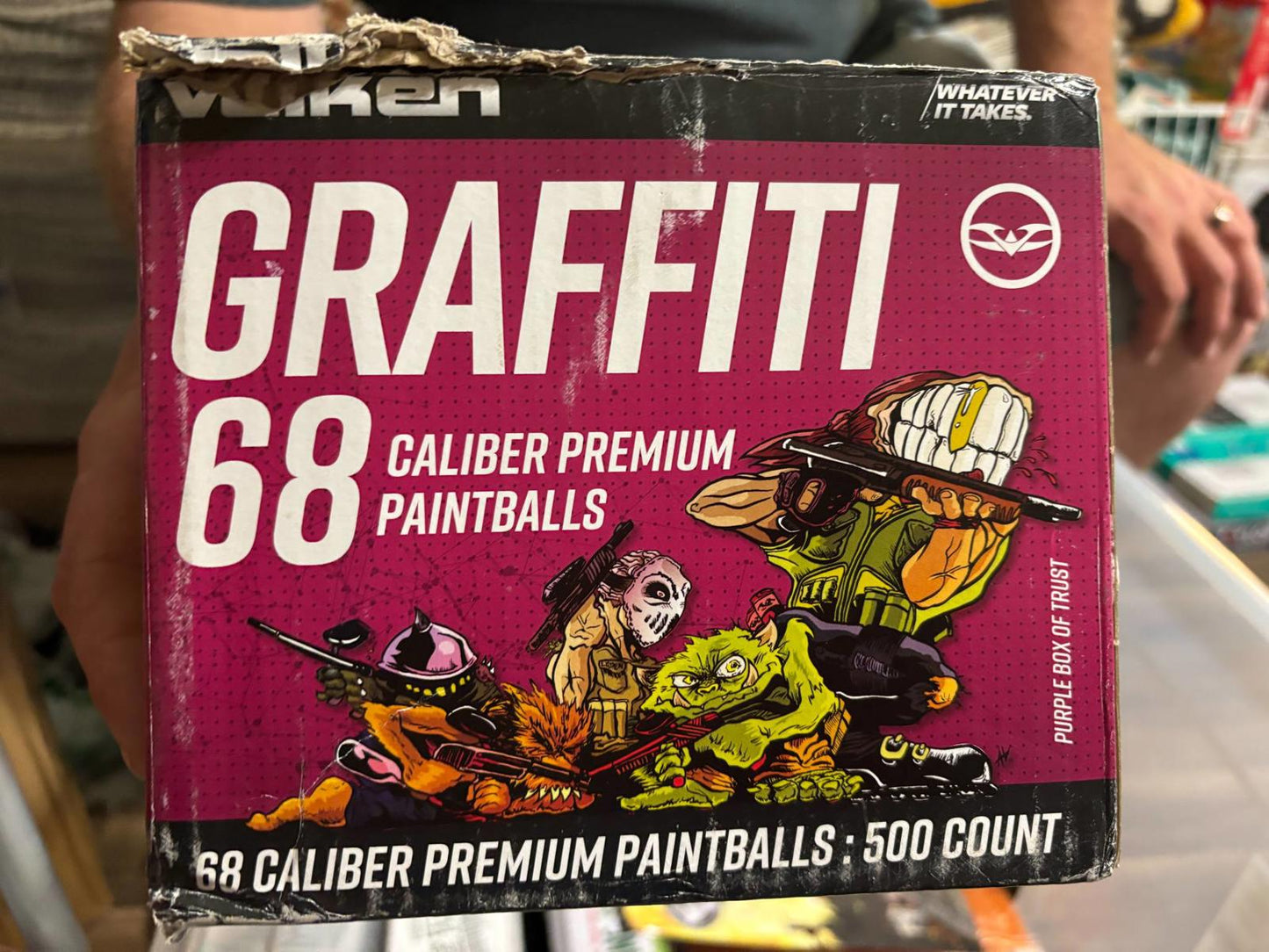 Graffiti 68 caliber premium paintballs box featuring colorful characters and vibrant design.