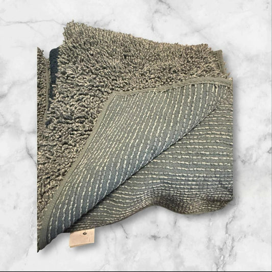 Soft gray bath towel with textured design and plush edges.