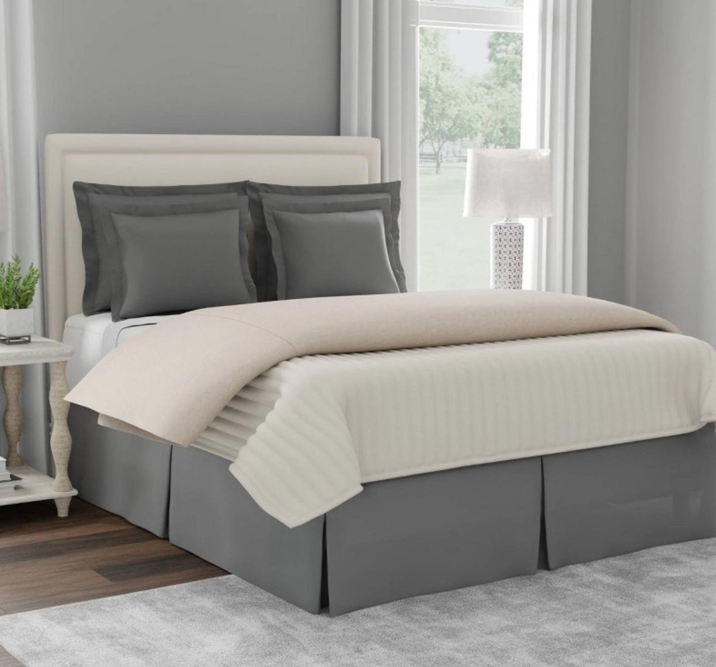 Gray Bed Skirt with Cream Bedding and Gray Pillows on a Stylish Bed.