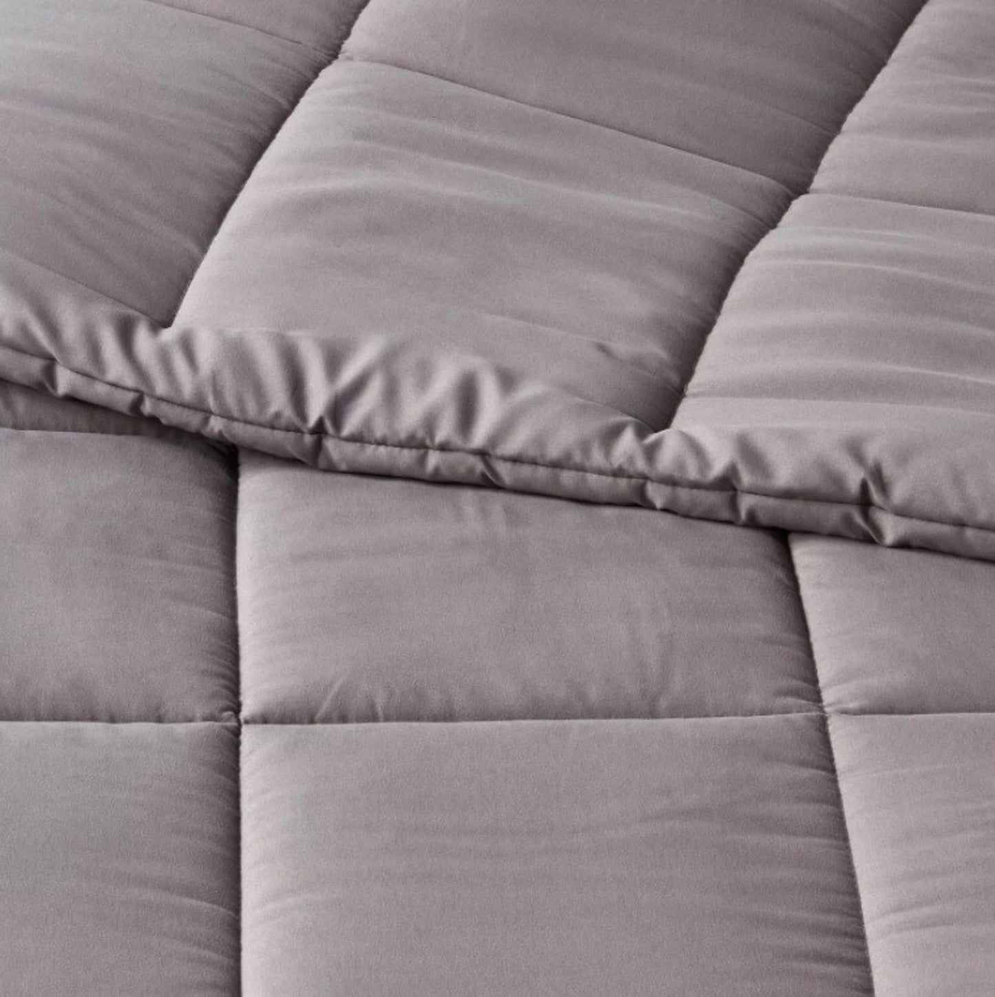 Gray Comforter Set featuring soft, quilted texture and plush fabric for cozy warmth.