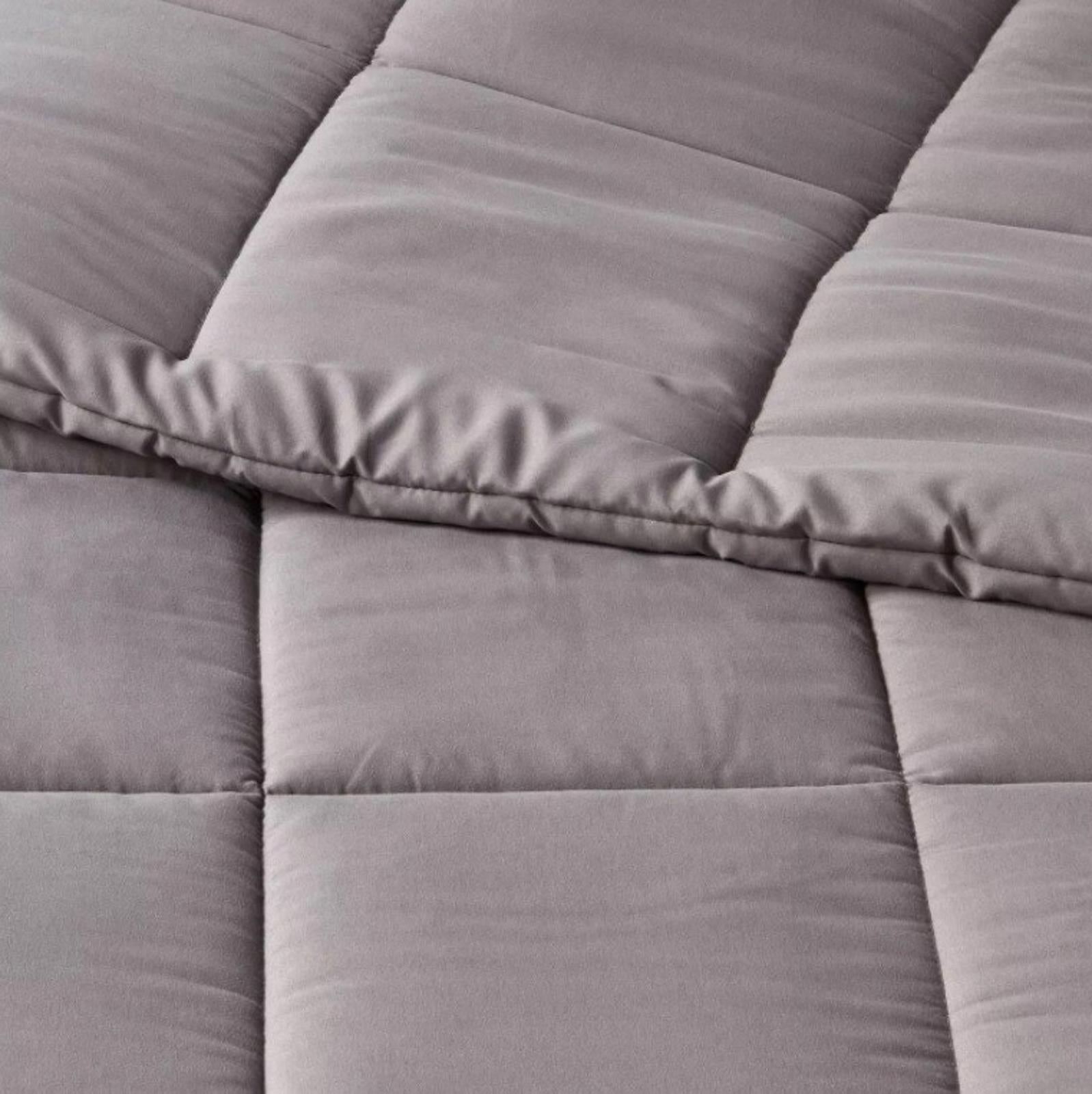 Gray Comforter Set featuring soft, quilted texture and plush fabric for cozy warmth.