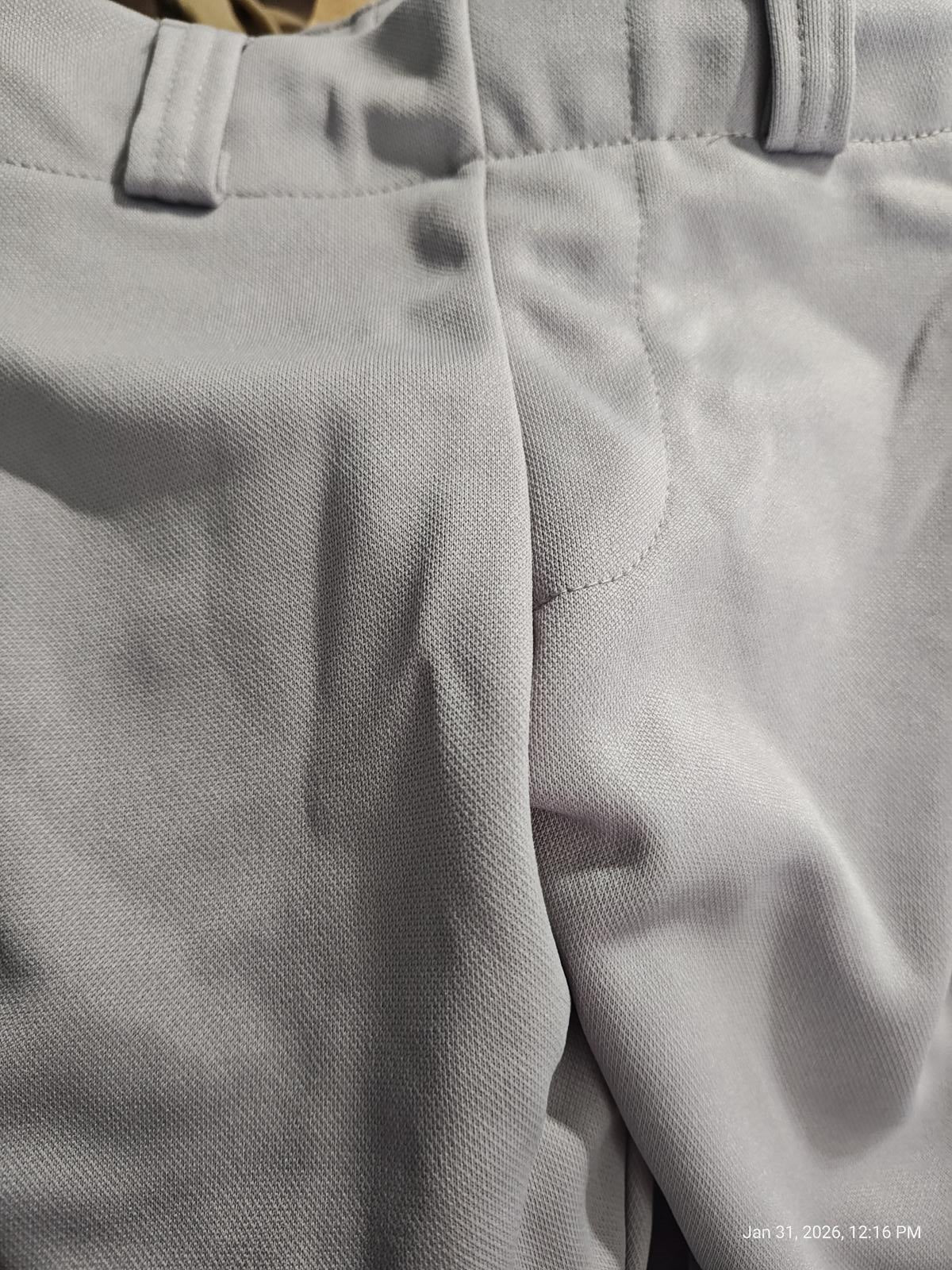 Gray dress pants featuring a smooth fabric texture and tailored fit.