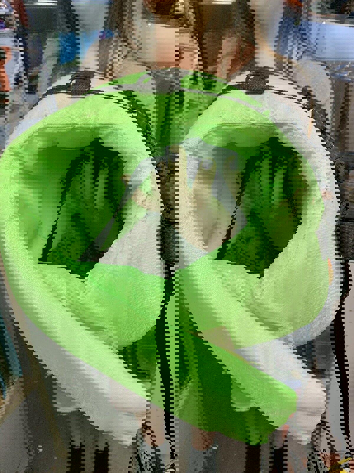 Green flotation device featuring a padded interior and adjustable straps.