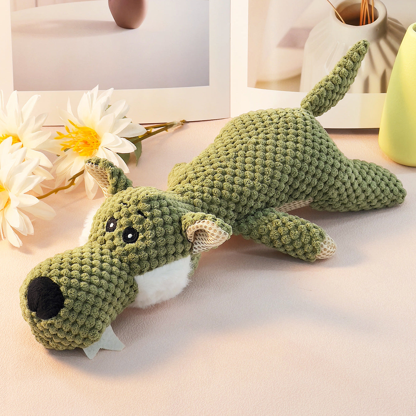 Green Knitted Dog Toy with cute features and soft texture.
