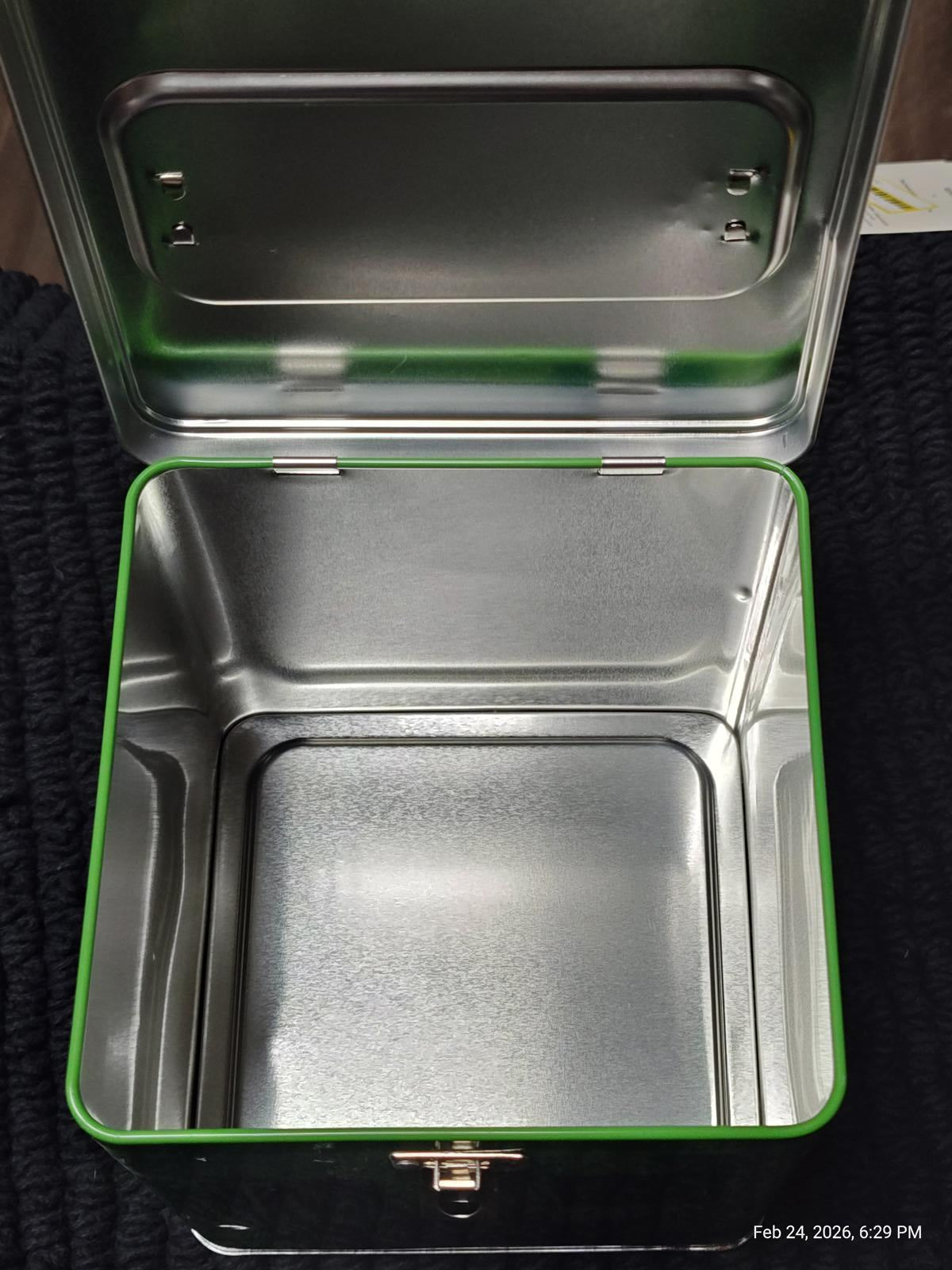 Green metal storage box with a shiny interior, perfect for organizing items.