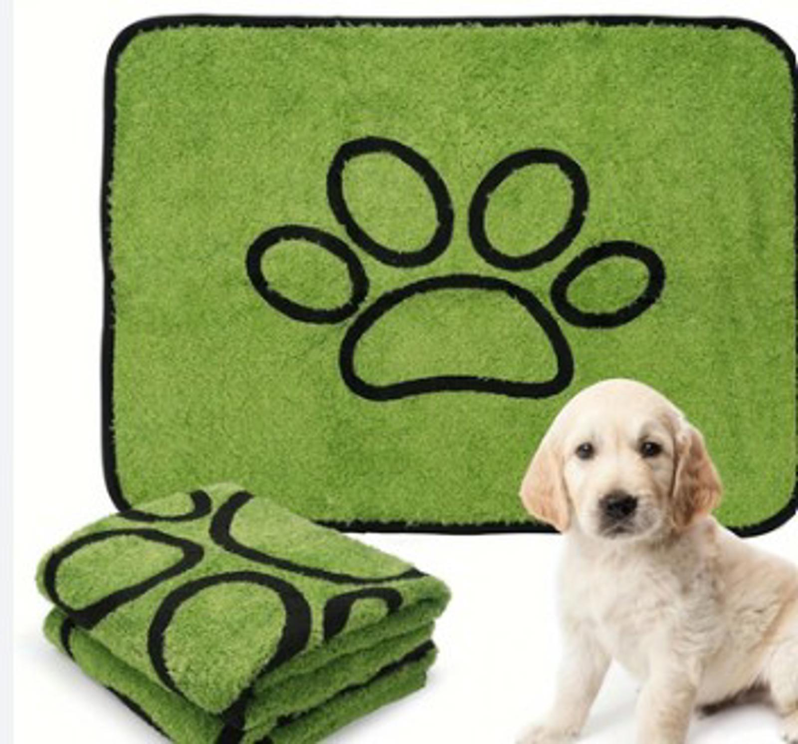 Paw Print Pet Mat in green color with a puppy beside it.