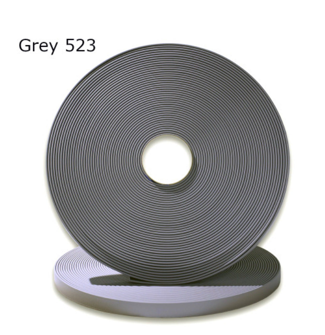 Grey 523 tape roll featuring a smooth, textured surface and a circular design.