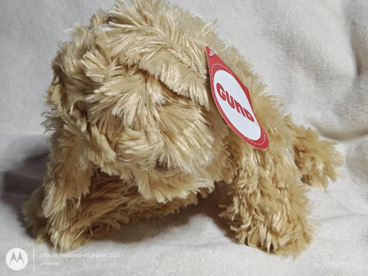 Gund plush dog toy in tan color with a soft, fluffy texture.