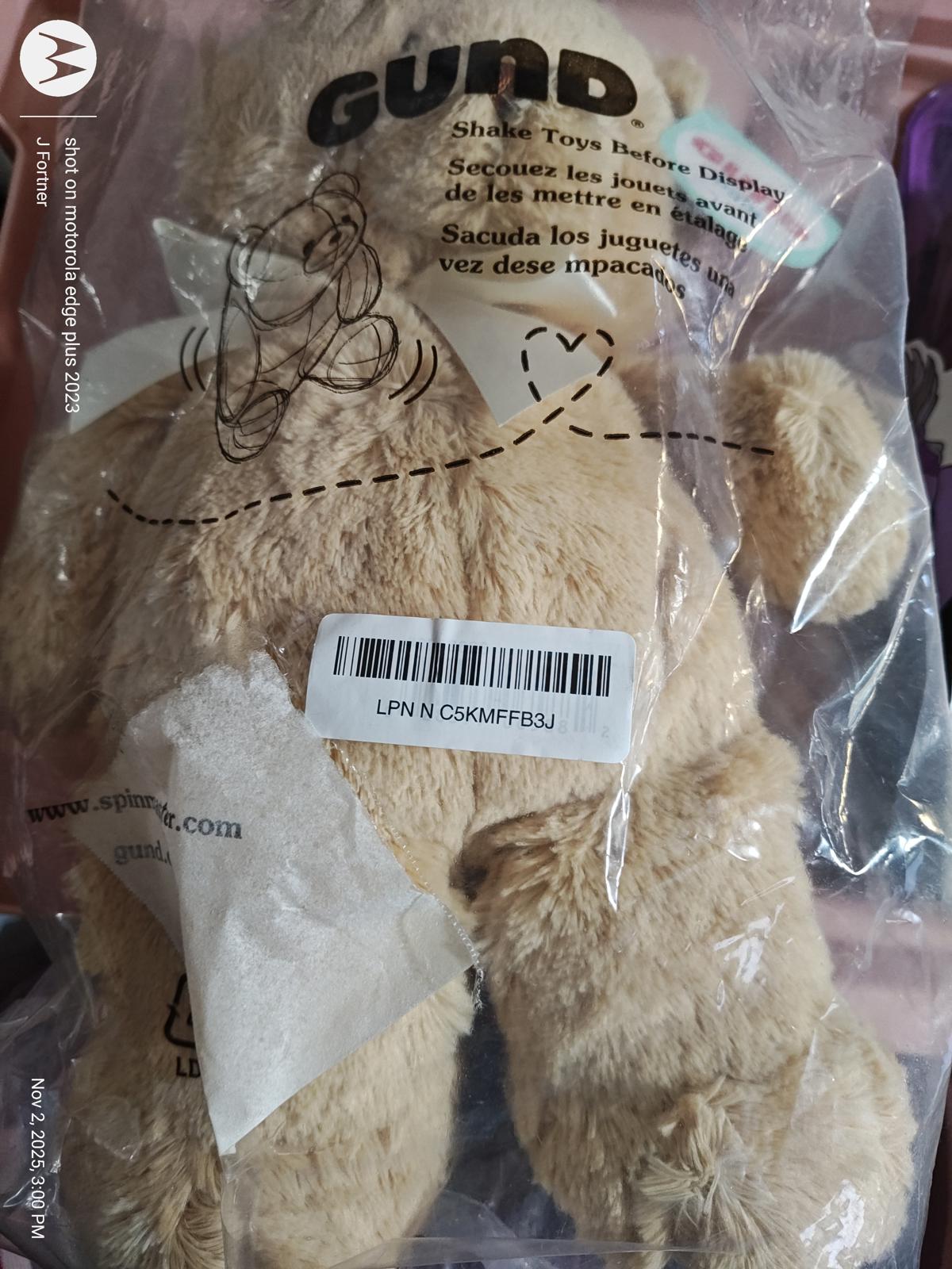 GUND plush teddy bear toy in packaging, soft beige color with a cute design.