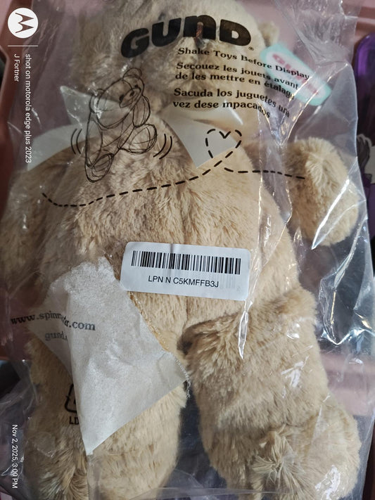GUND plush teddy bear toy in packaging, soft beige color with a cute design.