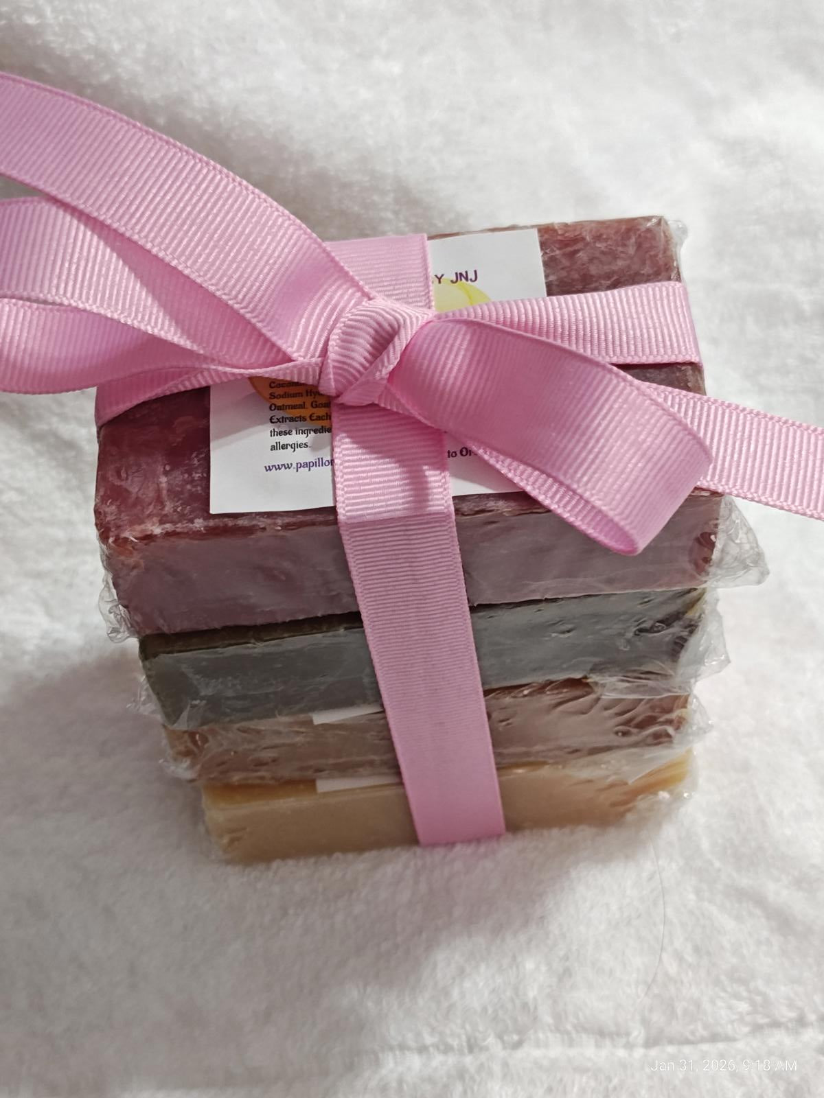 Handmade Soap Set with pink ribbon, featuring four colorful bars stacked together.