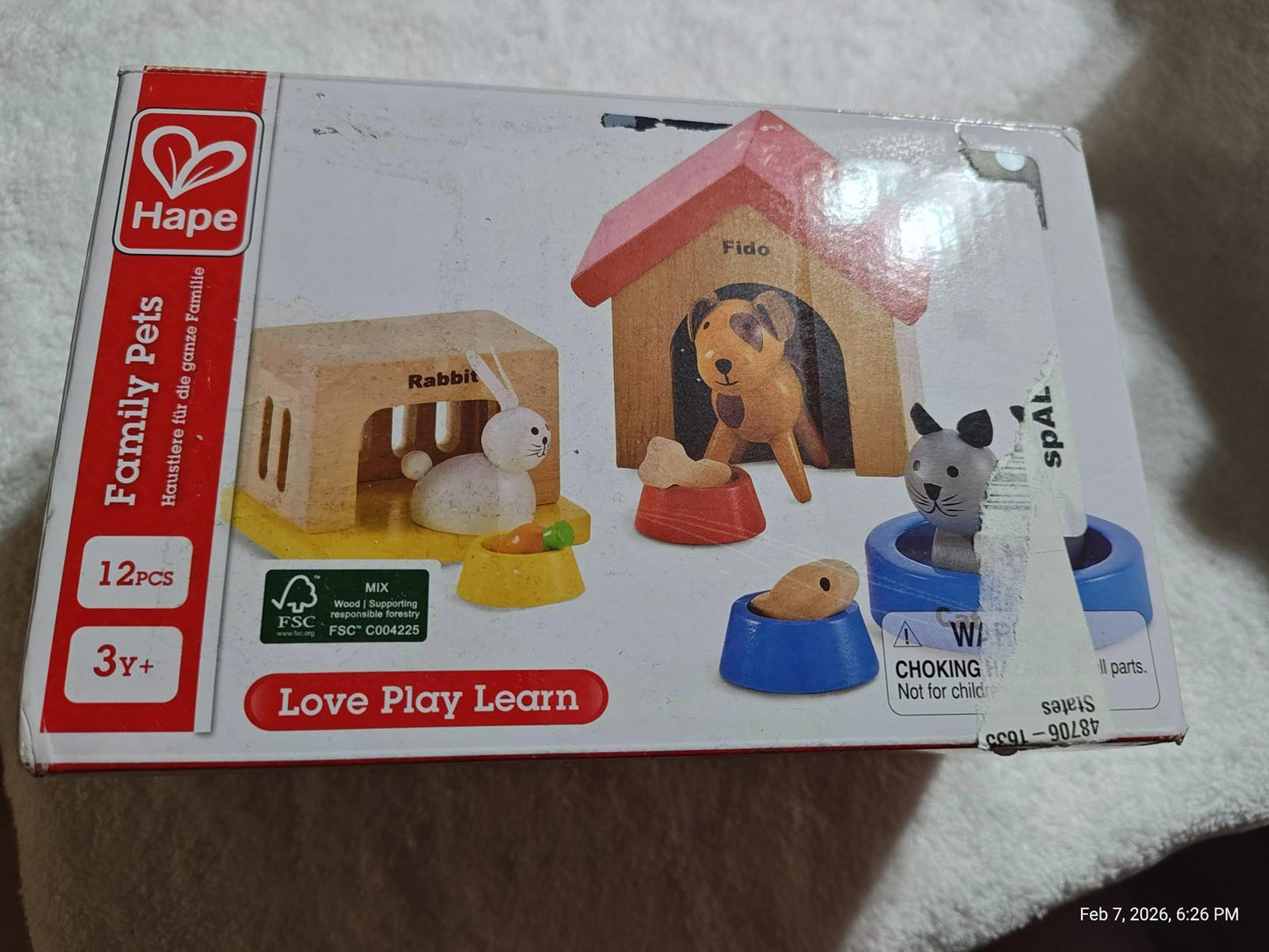 Hape Family Pets playset featuring a dog, cat, and various animal accessories for interactive learning.