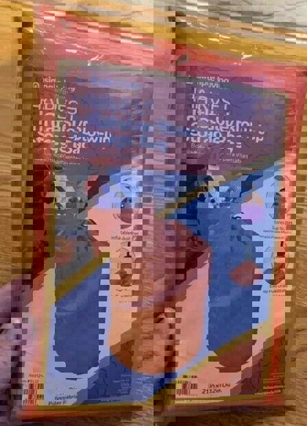 Harvest inflatable storage bag in bright orange packaging, featuring easy-to-use design.