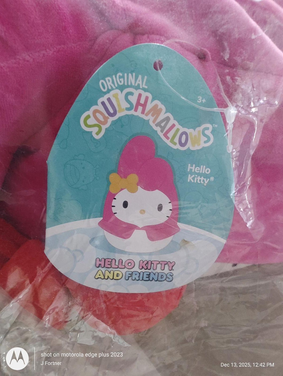 Hello Kitty Squishmallows tag featuring a cute design with a pink background.