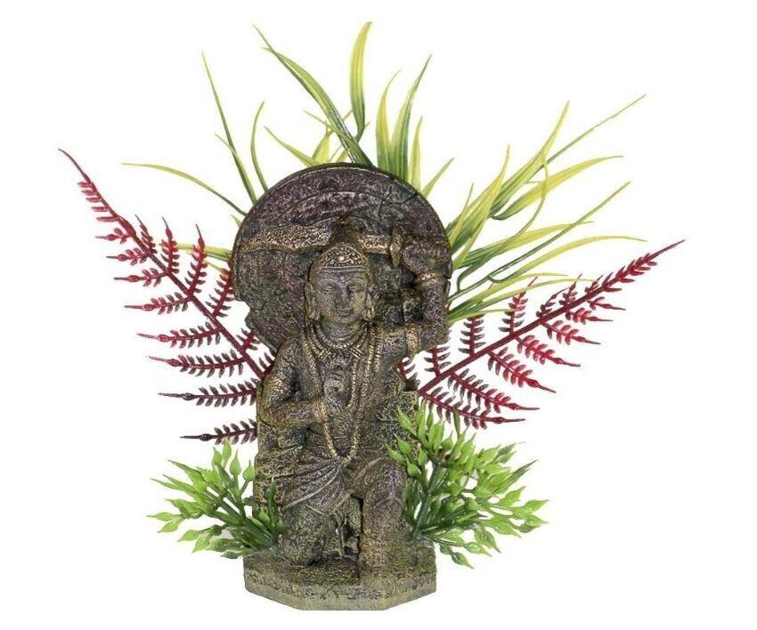 Hindu deity statue with intricate details surrounded by green ferns and decorative plants.