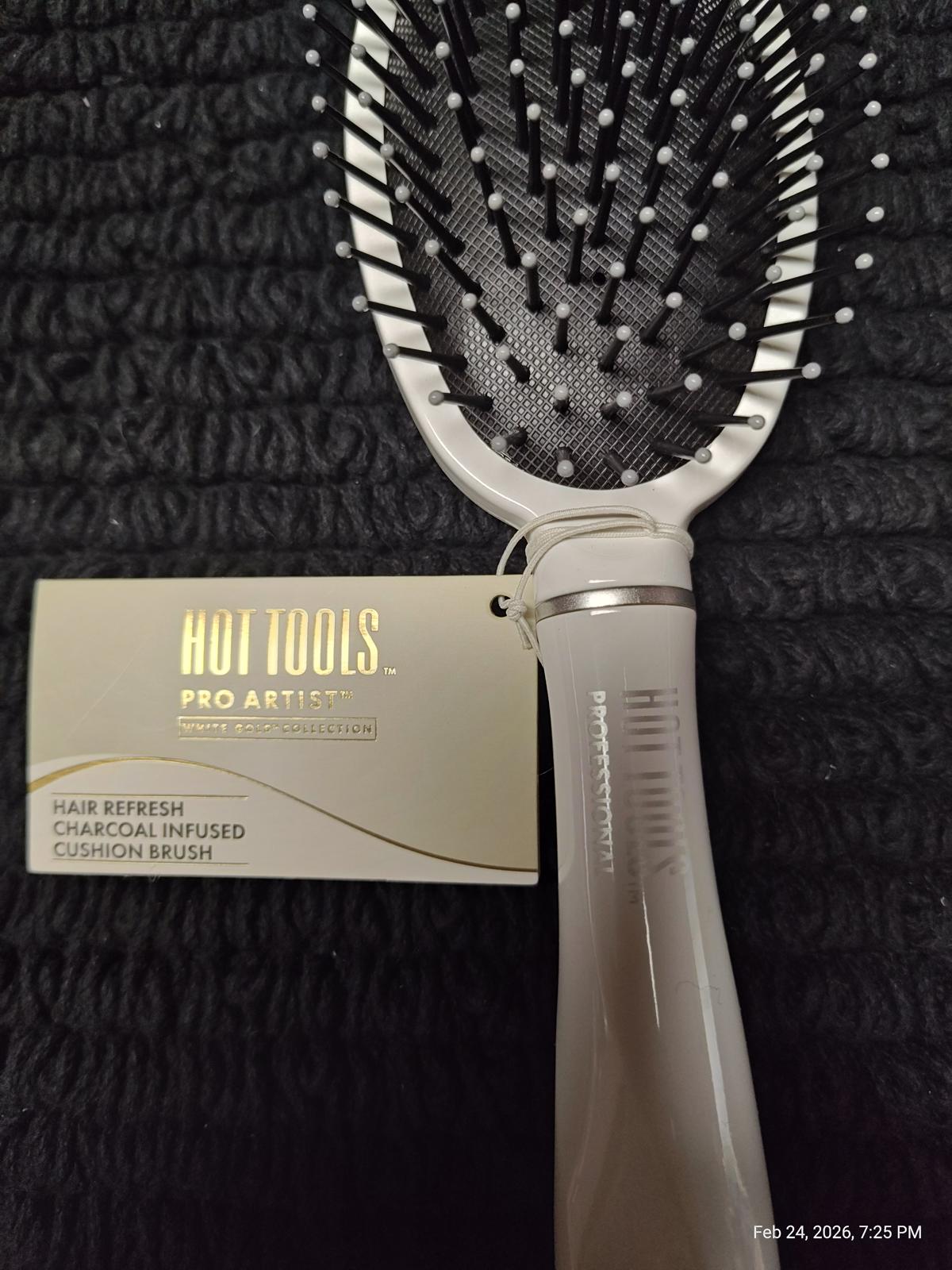 Hot Tools Pro Artist Charcoal Infused Cushion Brush with a sleek design and flexible bristles.