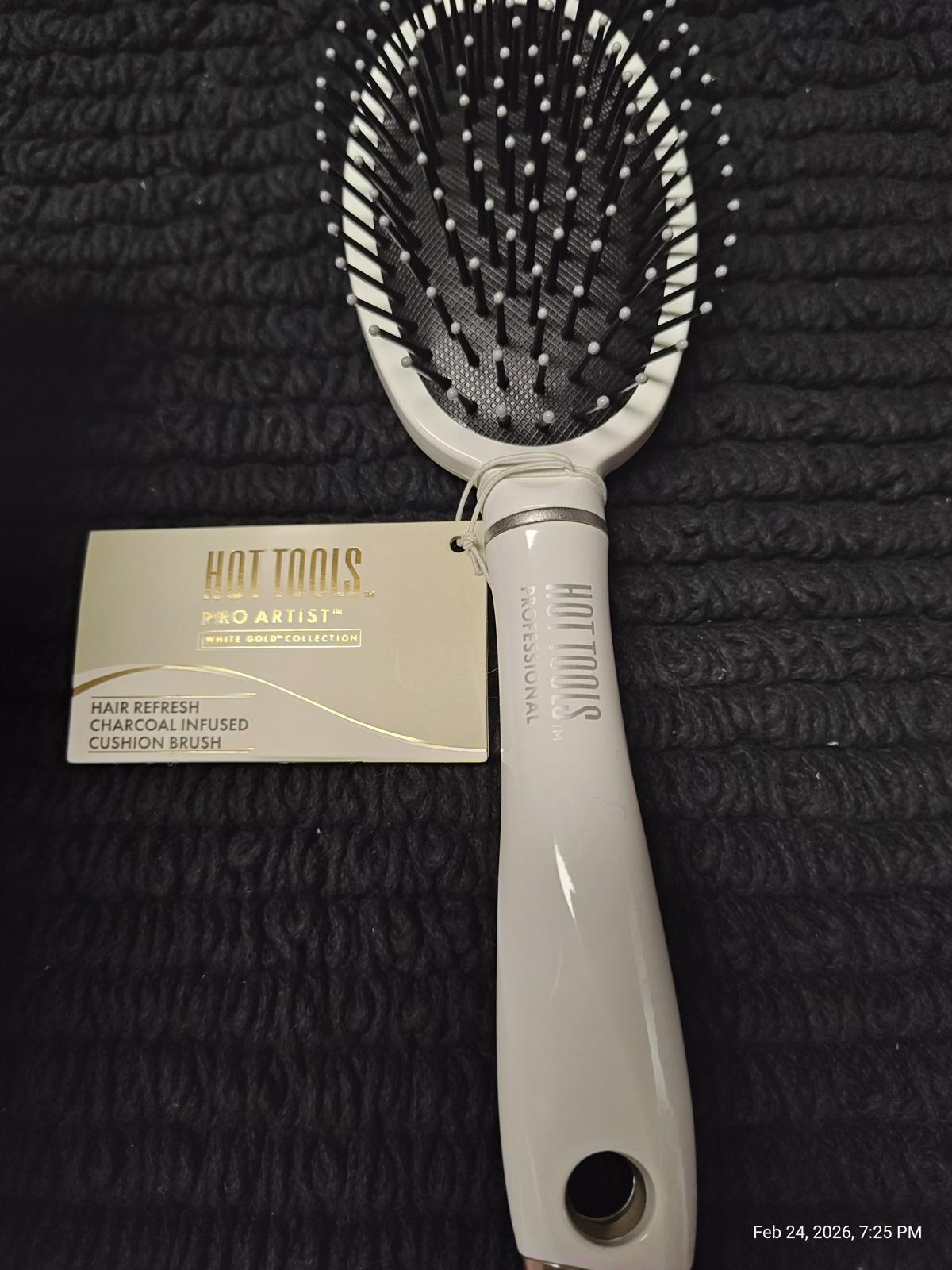 Hot Tools Pro Artist charcoal infused cushion brush with a sleek white handle.