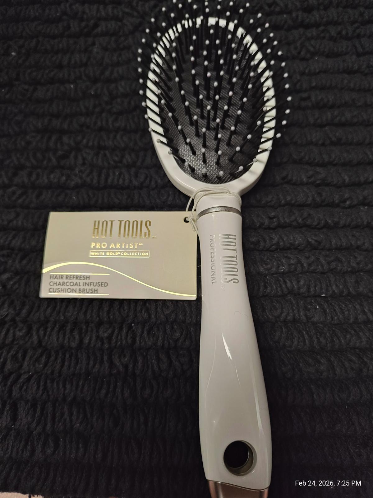 Hot Tools Pro Signature paddle brush with a sleek design and flexible bristles for detangling hair.