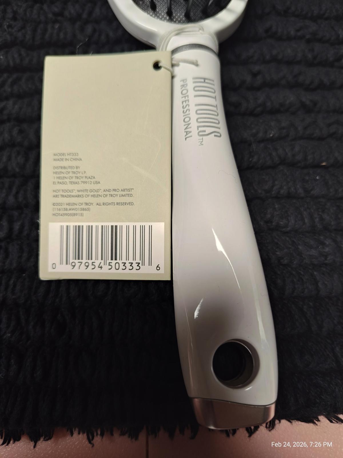 Hot Tools Professional hair styling tool with a sleek gray handle and tag.