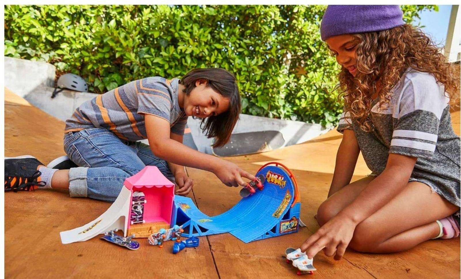 Hot Wheels Skatepark playset with kids enjoying ramps and vehicles.