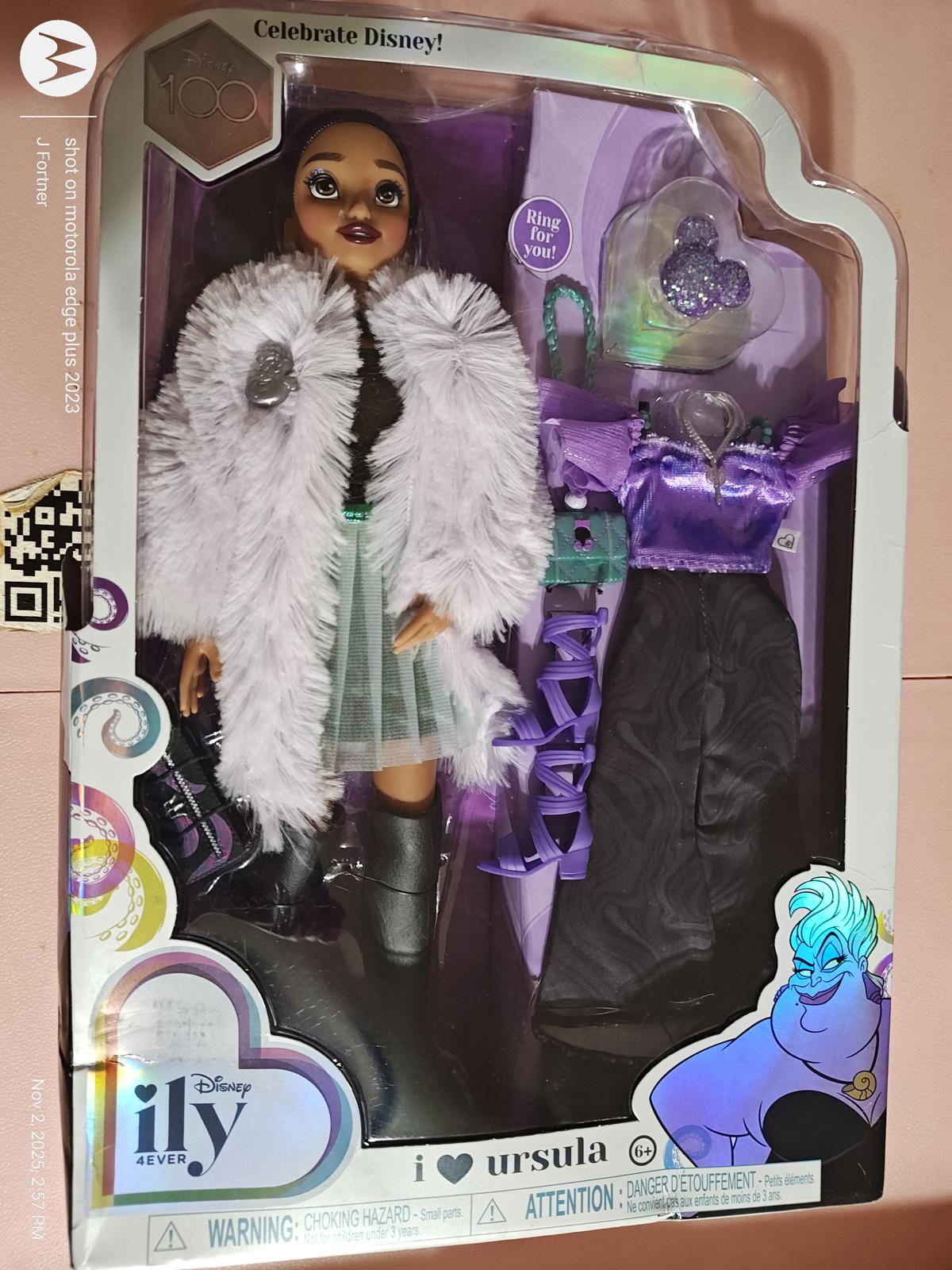 I Love Ursula doll featuring stylish outfit with purple accents and fluffy white coat.