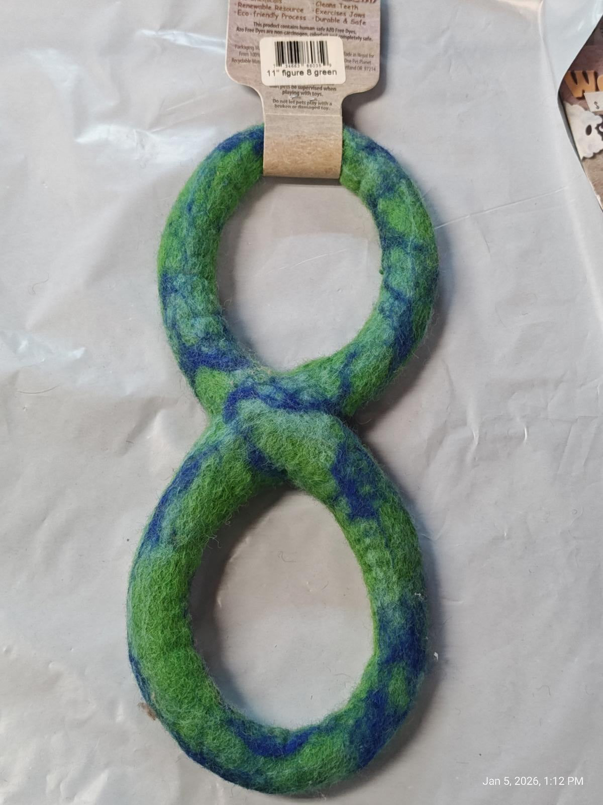 Green and blue infinity-shaped dog toy made of soft material.