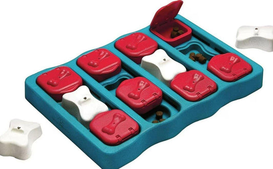 Dog puzzle toy with red and white compartments for treats, designed to stimulate pets.